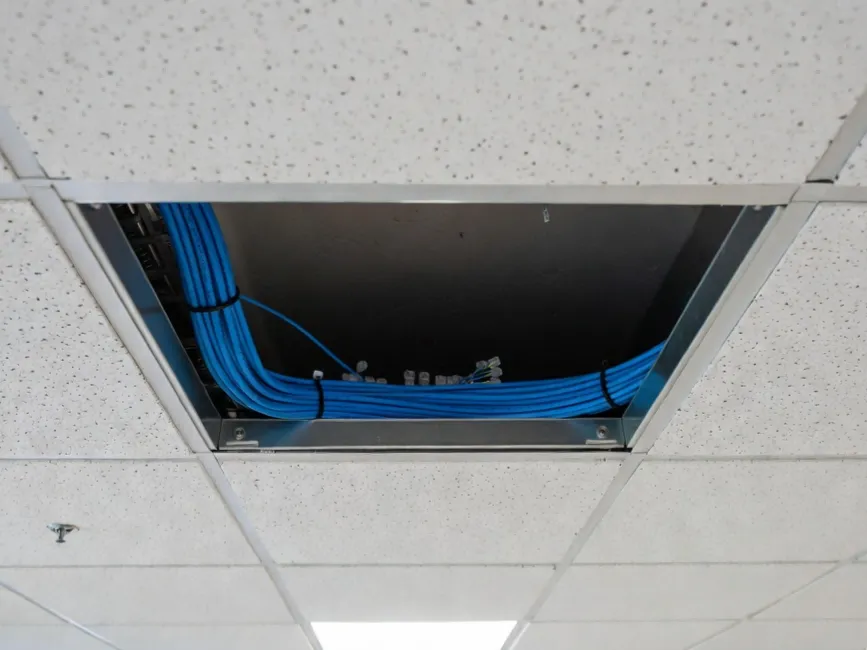 Cat6 plenum cable installation in commercial drop ceiling showing proper CMP fire rating compliance for HVAC air return spaces